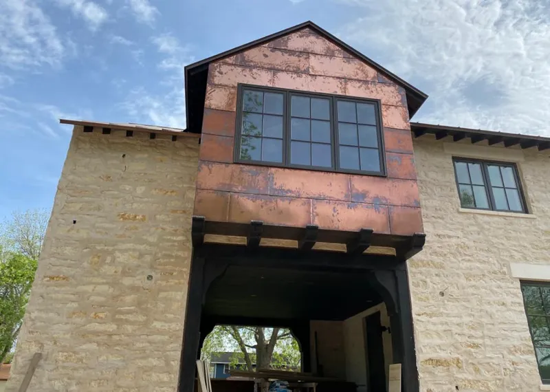 Copper metal panel facade on a stone building for Metal Roof Coating in Clark